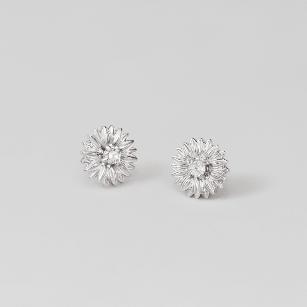 Silver Sunflower Stud Earrings, a pair of flower-shaped studs on a plain grey background, each