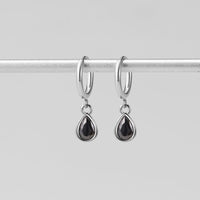 Silver Midnight Teardrop Earrings, hanging from a silver rod, black teardrop stones in silver